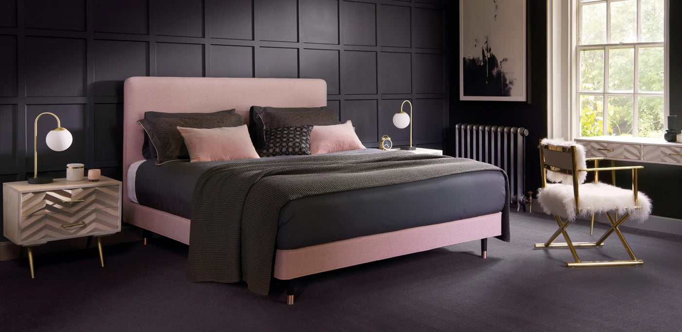hypnos pink bed in a black and pink bedroom