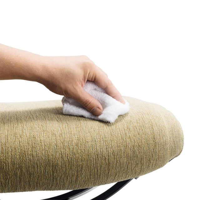 Stressless Fabric Care Kit in use, person is wiping fabric]